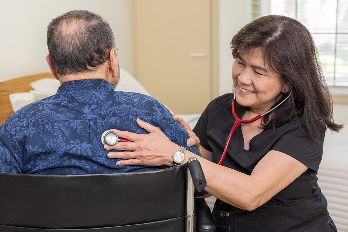 A nurse with an elderly resident at the Sundance Creek facility
