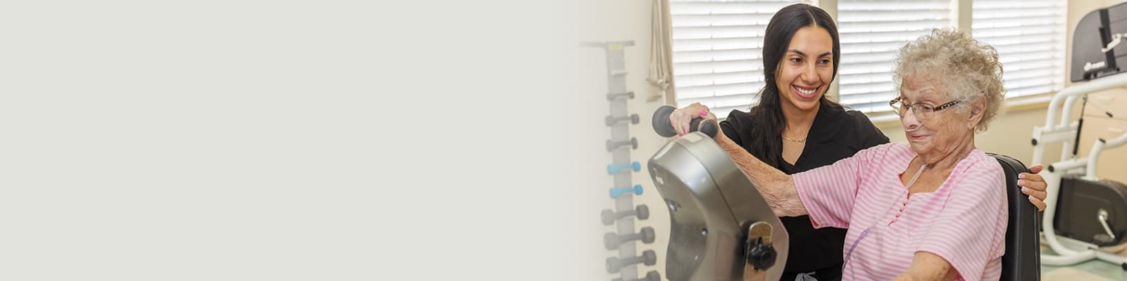 A rehab therapist with a resident in the Rehab gym of the Sundance Creek facility