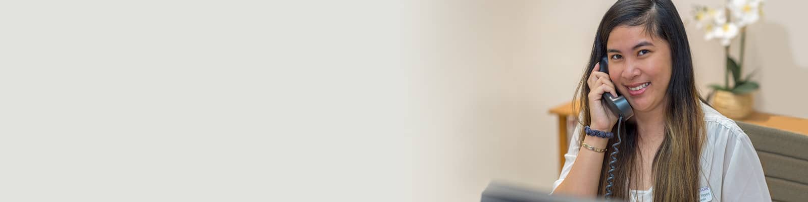 A staff member on the phone at the reception desk