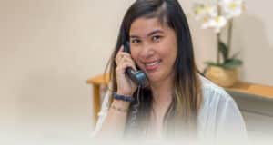 A staff member on the phone at the reception desk